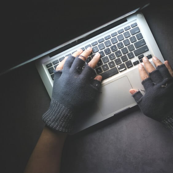 laptop open hands on keyboard wearing fingerless gloves